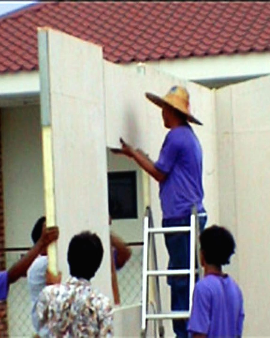 Ali Ibrahim Holdings workers installing a precast wall panel on a building project