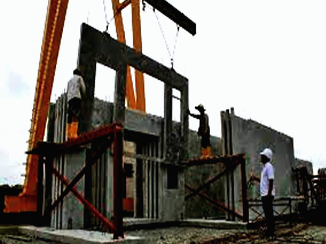 Mobile crane lifting a precast concrete panel into position on site
