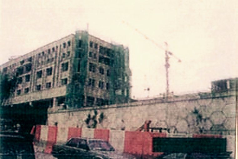 Multi-storey campus building under construction with a tower crane on site